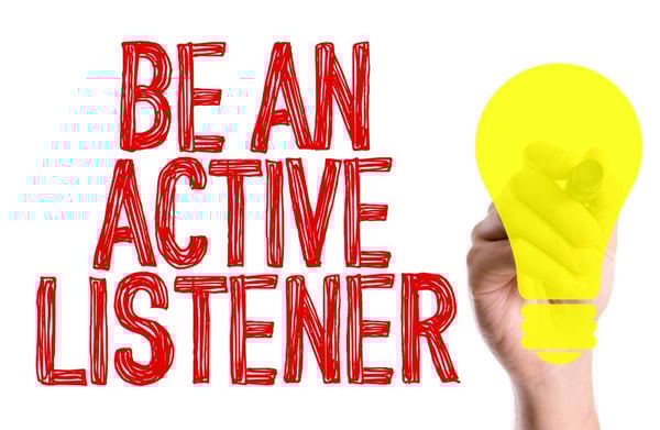 Hand with marker writing the text Be An Active Listener