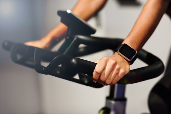 woman-gym-doing-spinning-cyclo-indoor-with-smart-watch